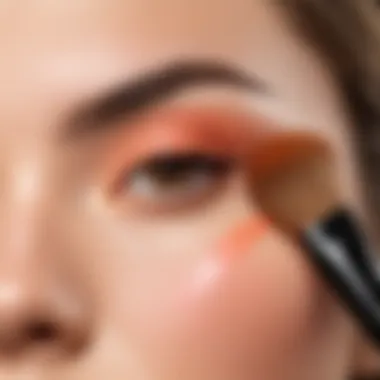 A makeup artist applying peach blush using a brush, demonstrating technique and application.