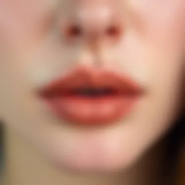 A close-up of lips featuring a trendy nude lipstick shade.