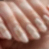 Elegant French almond nail design featuring intricate patterns