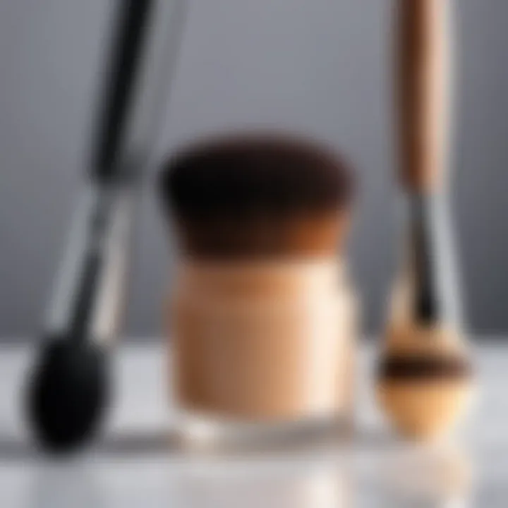 A makeup brush and sponge beside concealer products