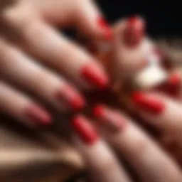 A close-up view of vibrant red nails with intricate nail art designs.