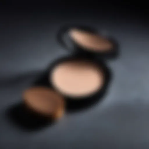 A close-up of a makeup powder compact with a soft brush beside it.