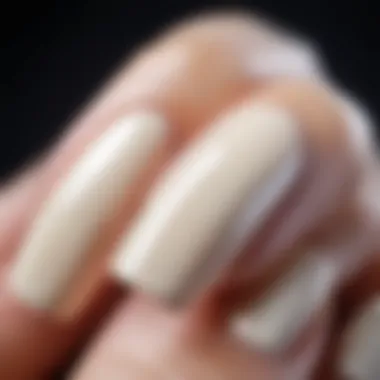 Close-up of bone color nail polish on natural nails