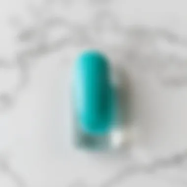 Turquoise nail polish swatch on a marble background