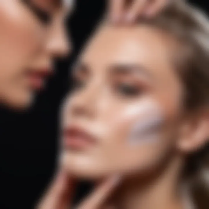 Close-up of a makeup artist applying primer to a model's face